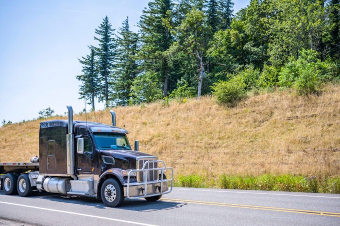 flatbed truck moving across midwestern USA